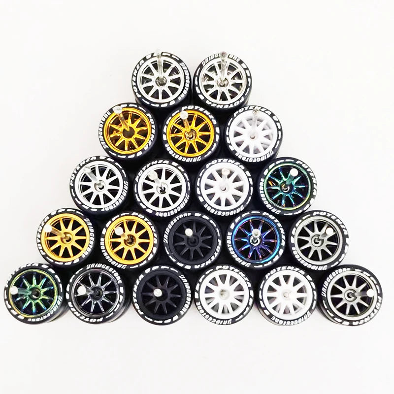 A collection of 10 pairs of 1:64 scale alloy car wheels and tires arranged in a pyramid formation.