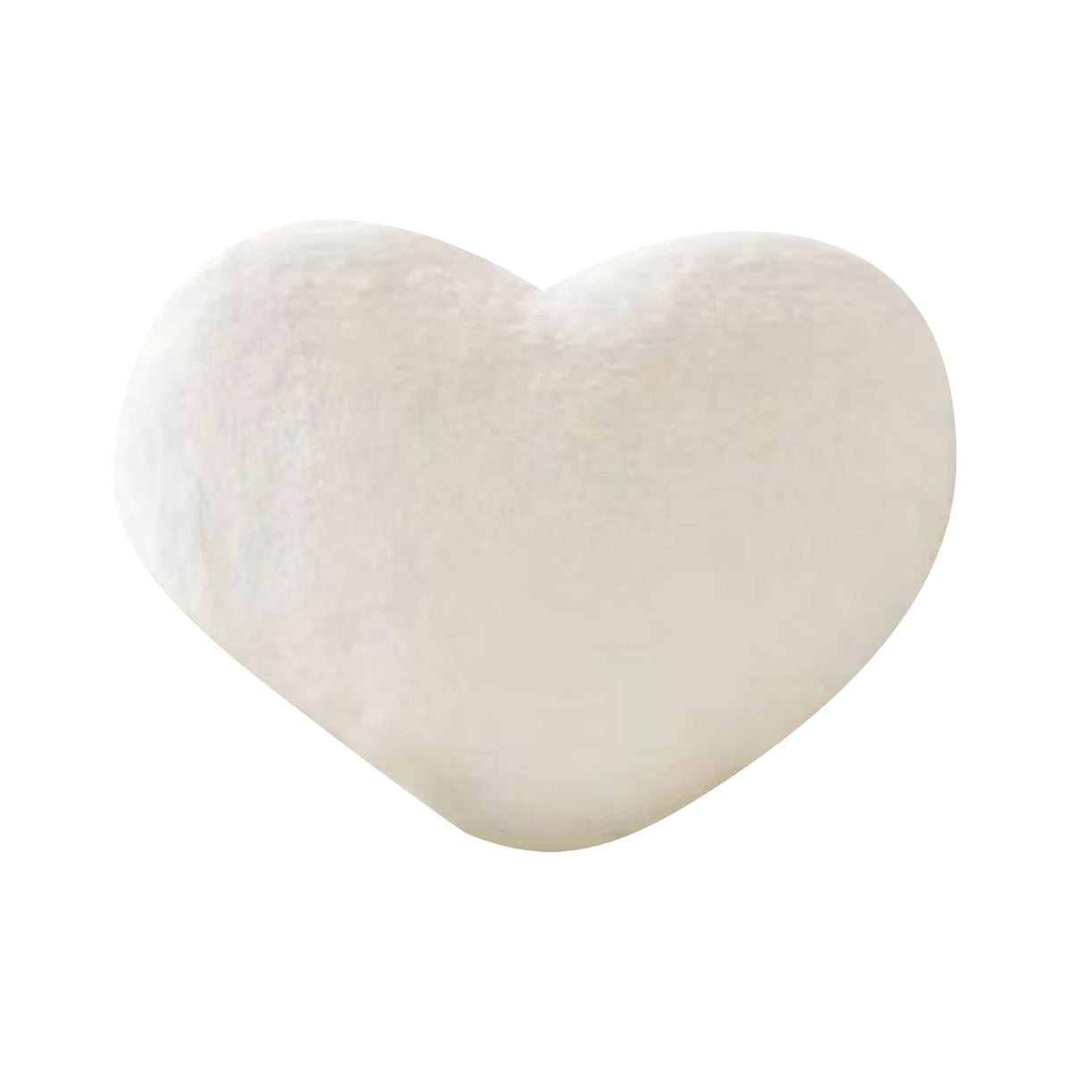 A soft, white heart-shaped plush throw pillow for cozy decor.