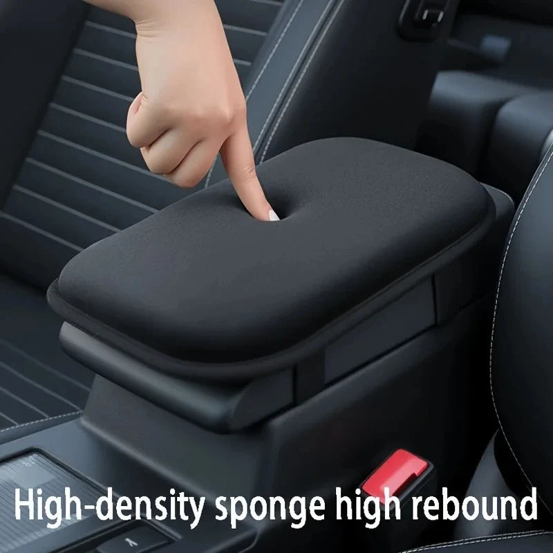 A hand is pressing a black, high-density sponge cushion on a car armrest for high rebound and scratch protection.