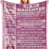 A pink fleece throw blanket with inspirational text about a daughter and love