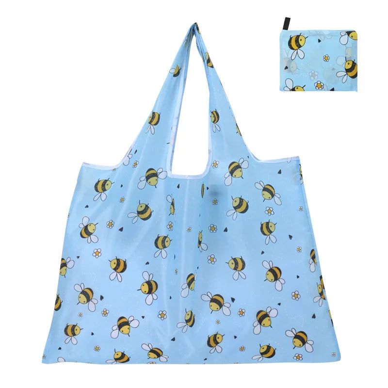 Light blue reusable shopping tote bag featuring a pattern of yellow and black bees.