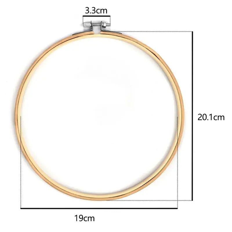 A circular bamboo embroidery hoop with a gold-toned frame and an adjustable screw mechanism.