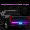 A black pickup truck with an RGB LED tail light bar installed on the tailgate, showing purple and blue lights.