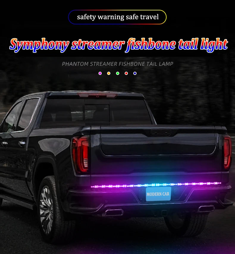 A black pickup truck with an RGB LED tail light bar installed on the tailgate, showing purple and blue lights.