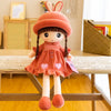 An adorable orange rabbit fairy plush doll with long ears and pink accents sitting on a wooden table.