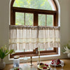 Beige gingham cafe curtain with crochet lace trim hanging in a wooden window frame.