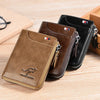 A brown leather wallet with a zipper and flag detail is shown next to a black version on a wooden surface.