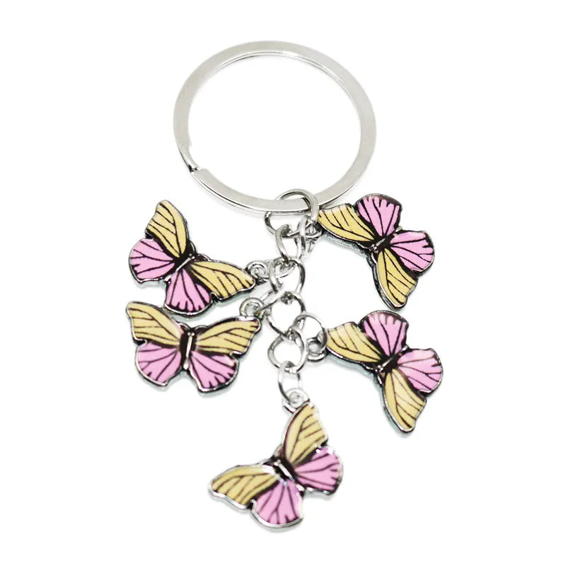Silver keychain charm featuring a colorful butterfly design with pink and yellow wings