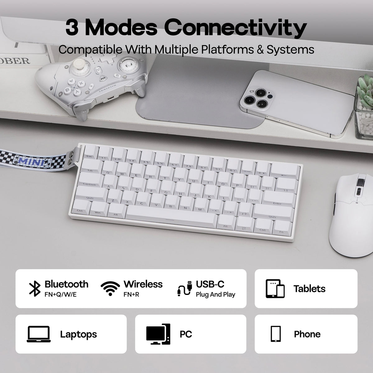 A white magnetic gaming keyboard is shown alongside various electronic devices including a controller, smartphone, and tablet