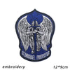 A dark blue patch featuring a silver archangel St. Michael with wings and a halo, embroidered on fabric.