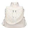 A beige leather backpack with light floral embroidery and adjustable straps.