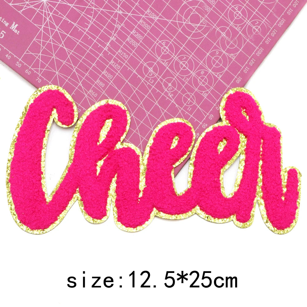 Pink chenille letter patch spelling Cheer with gold glitter outline