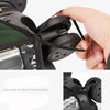 A hand is opening a black waterproof suitcase cover with an easy access zipper.