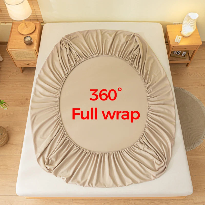 A beige fitted bed sheet is shown fully wrapped around a mattress, demonstrating a 360 degree coverage.