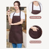A woman models a dark brown waterproof apron with a comfort strap and a practical pocket.