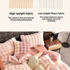 A pink and white plush bedding set featuring velvet fabrics with various textures and a decorative pillow.