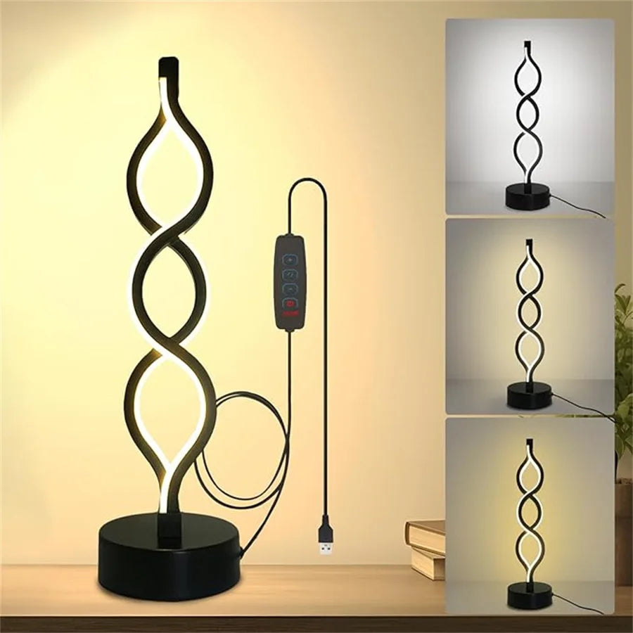 A black, seaweed-shaped desk lamp with a soft ambient glow is displayed on a wooden surface.