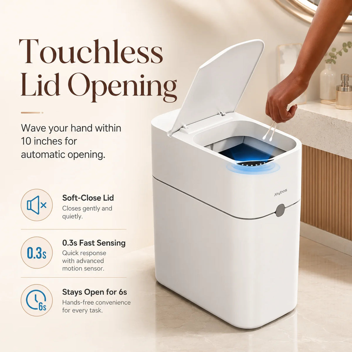A white touchless lid opening trash can with a sensor, shown in use on a countertop.
