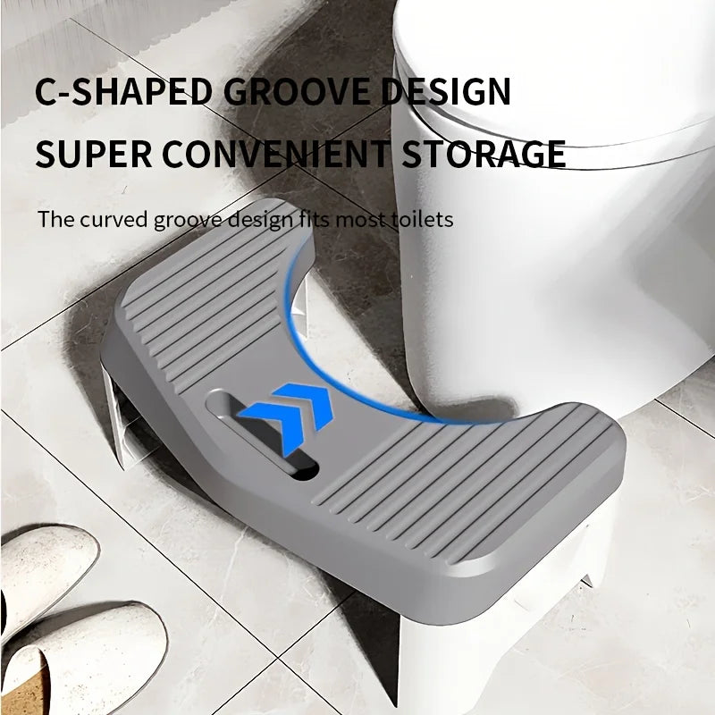 A gray C-shaped groove design storage shelf for toilets shown in a bathroom setting.