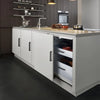A modern kitchen cabinet with matte black stainless steel pulls and a light countertop and dark gray cabinetry.