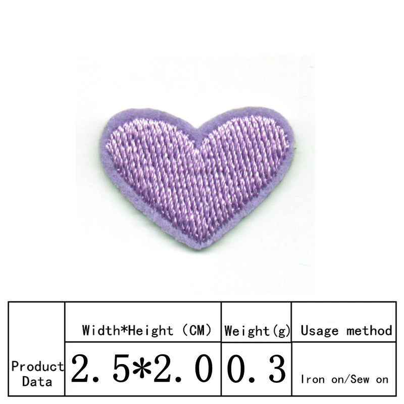 A purple heart shaped embroidery patch with a textured fabric surface.