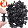 A pile of black heavy-duty plastic fasteners and screws is shown being held by a hand.