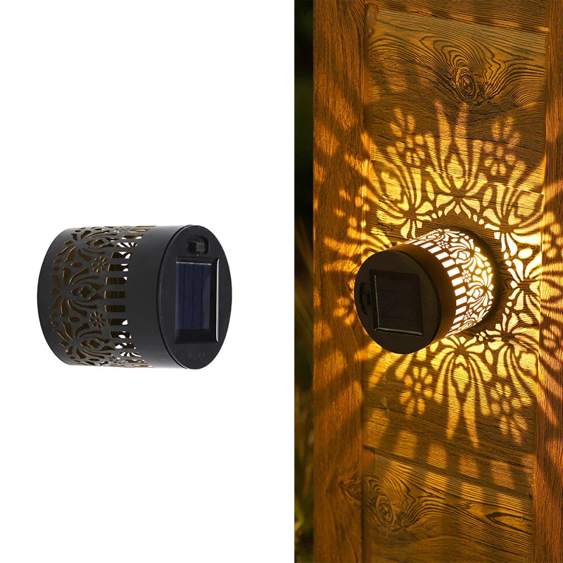 Una lámpara de pared mandala solar proyecta sombras florales intrincadas sobre una superficie de madera.