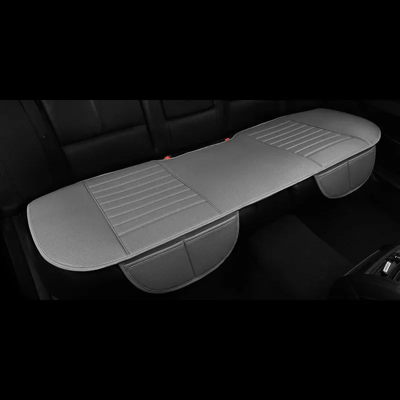 A gray breathable PU leather car seat cover is shown placed on a black car seat interior.