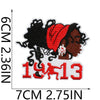 Embroidered patch featuring a silhouette of a woman in red and black, with the year 1913 below it.