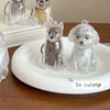 Clear resin pet figurines of a cat and a dog sitting on a white plate.