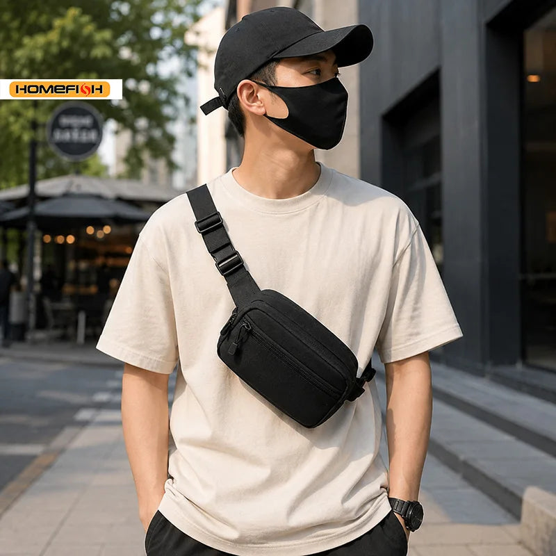 A young man wearing a black tactical MOLLE waist pack and a black face mask, standing outdoors.