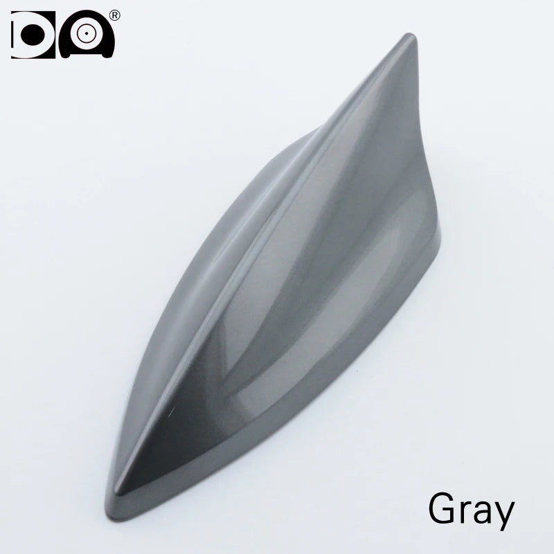 A gray 5D shark fin car antenna with a smooth, aerodynamic shape.