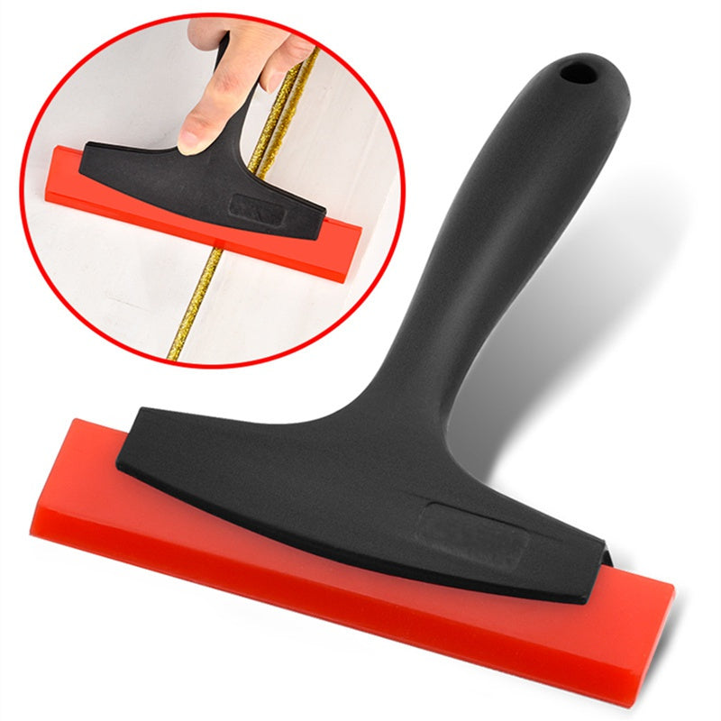 A black silicone scraper tool with a red rubber base is shown alongside an inset demonstrating its use.