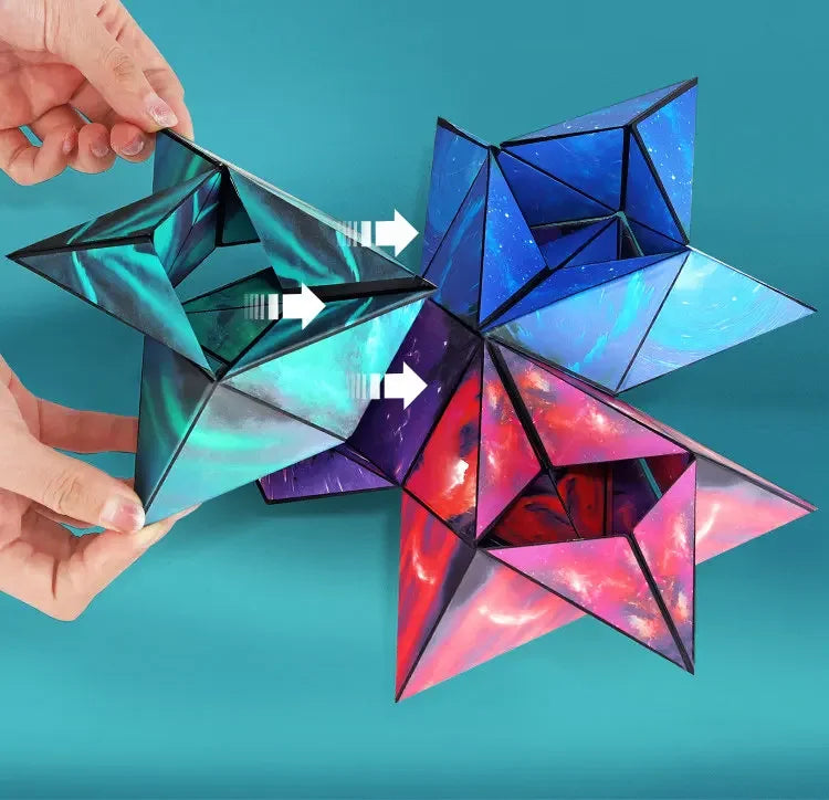 A hand holds a colorful magnetic fidget cube puzzle that transforms into a 3D geometric shape.