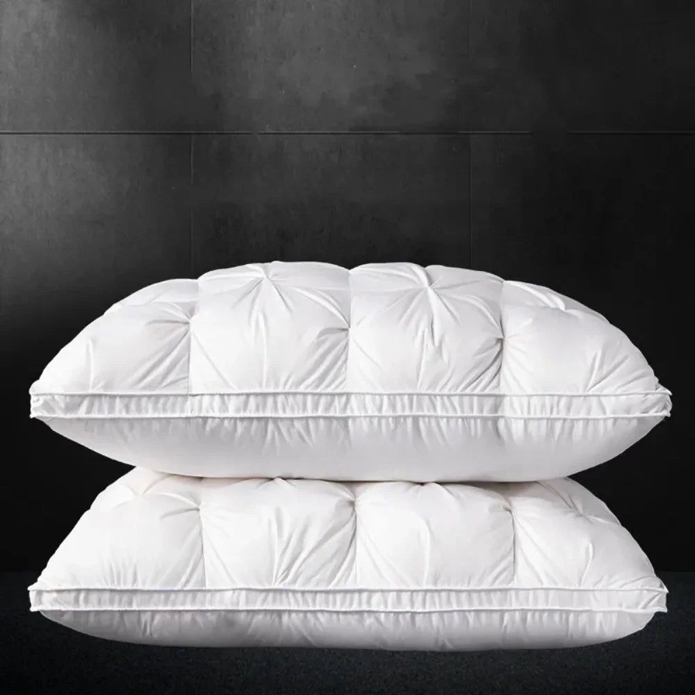A stack of white luxury hotel-style bed pillows against a dark background.