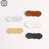 A collection of five handmade PU leather sewing labels in various shades of brown and white with the text Made With Love
