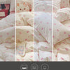 A display showing four lighting conditions—Dim, Warm, Cold, and Natural Light—on a white duvet cover set with pink bow prints
