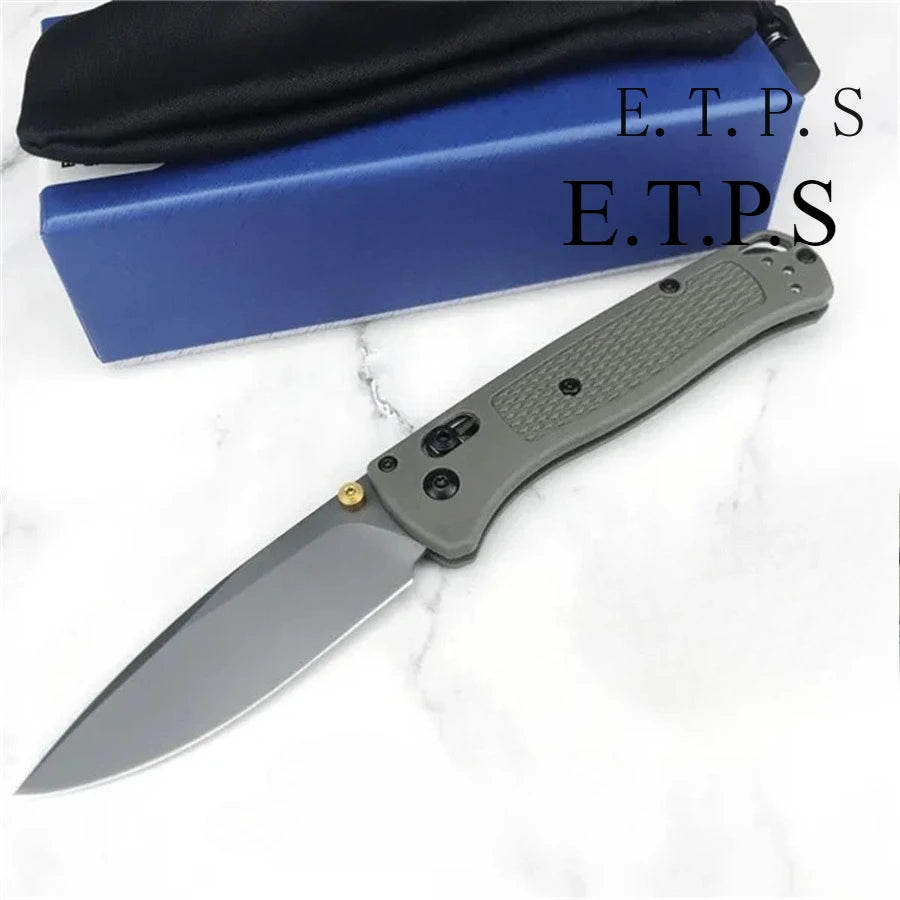 A gray folding pocket knife with a drop point blade is shown next to its blue sheath.