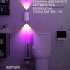 A modern bathroom features an ultra-long battery life wall light illuminating a toilet area.