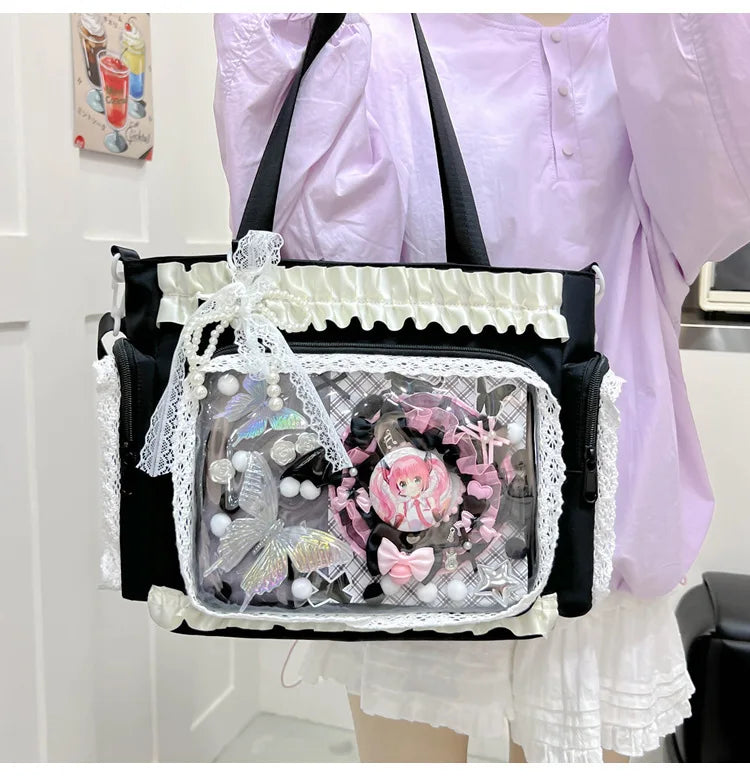 A transparent shoulder bag with black trim and white lace trim is carried by a person wearing a light purple blouse.