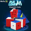 A red and blue magnetic cube is shown in a close-up, with a triangular piece next to it against a dark background.