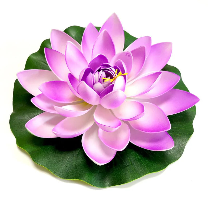 A vibrant pink lotus flower with purple accents rests on a green leaf.