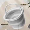 A white foldable portable wash basin with a handle is shown, demonstrating its design features.
