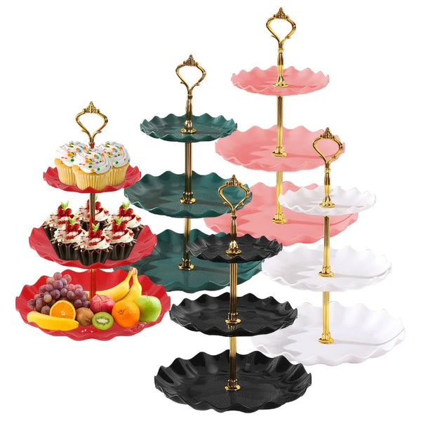 A three-tier gold and pink dessert stand displaying cupcakes and pastries.