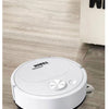 A white robot vacuum cleaner is shown on a wooden floor next to a vertical white object.