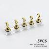 Five gold reusable nail glue clay pieces displayed on a clear acrylic surface.