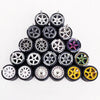A collection of ten 1:64 scale alloy car wheels and tires arranged in a pyramid formation.