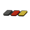 A set of three colored grille emblem stickers in black, red, and yellow.