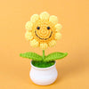 Handcrafted crochet sunflower with a green stem growing in a white pot