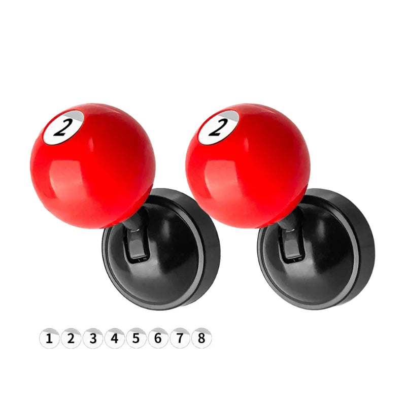 Two red metal push-to-start button covers with billiard ball designs and numbered indicators